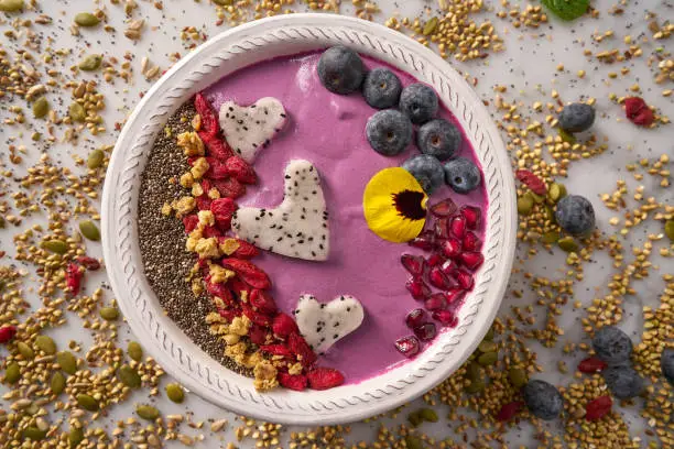 Acai bowl smoothie pitaya hearts blueberry goji chia pomegranate and seeds for Valentines day