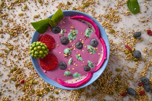 Acai bowl smoothie with chia strawberry blueberry seeds and pitaya dragon fruit
