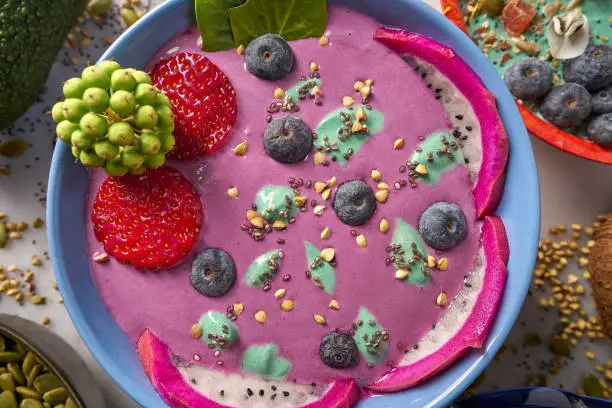 Acai bowl smoothie with chia strawberry blueberry seeds and pitaya dragon fruit