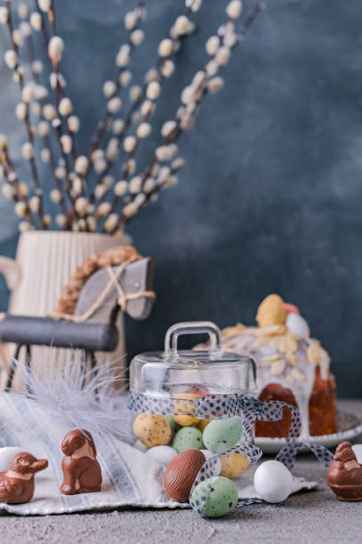 istock Easter orthodox sweet bread, kulich and colorful quail eggs with willow branches. Holidays breakfast concept with copy space. Retro style. 1140557982
