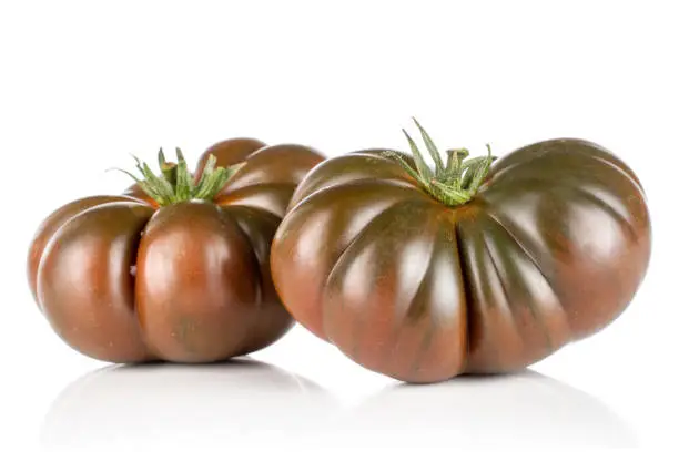 Group of two whole fresh tomato primora isolated on white background