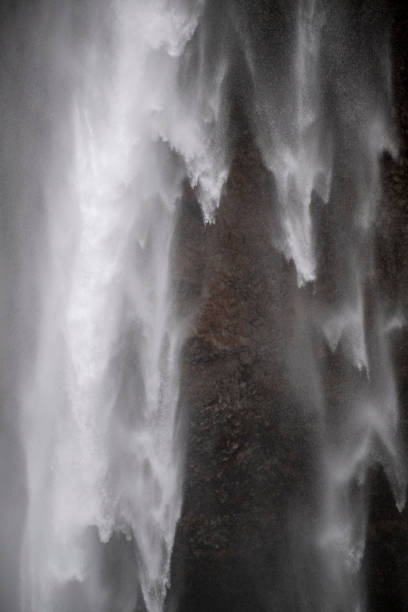istock Close up of a water fall with wind blown spray 1140561521