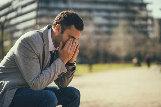 istock Exhausted businessman in park 1140562888