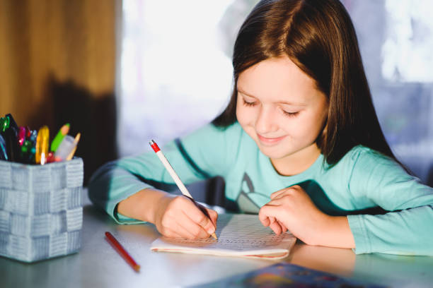 istock the girl is a first grader in the room doing homework 1140562903