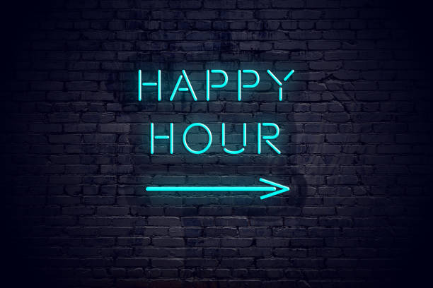 Brick wall with neon arrow and sign happy hour. stock photo