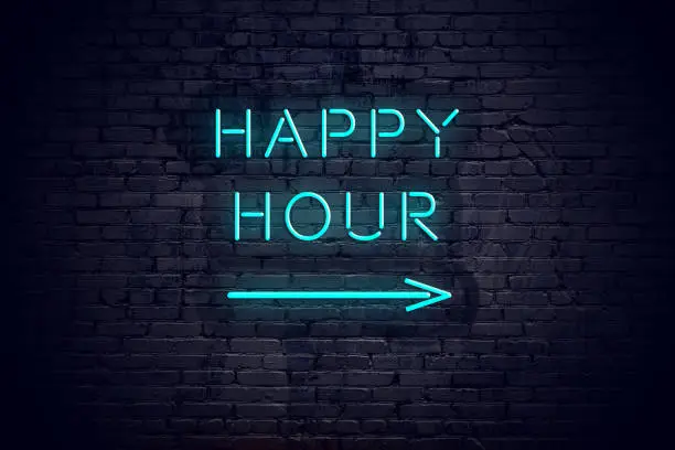 Brick wall with neon arrow and sign happy hour