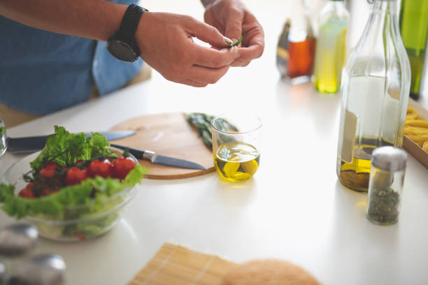 istock Man preparing herbs for delicious vegetable salad 1140563965
