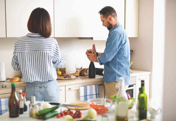 istock Beautiful couple preparing for romantic dinner in kitchen 1140564020