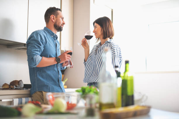 istock Beautiful couple enjoying alcohol drinks at cozy kitchen 1140564029