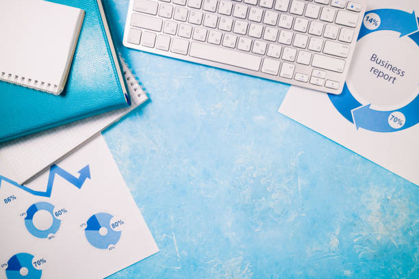 istock Office desk with business supplies. Workplace with papers, documents, keyboard, notebooks. Business report, office work and deadline concept 1140564155