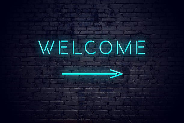 istock Brick wall with neon arrow and sign welcome. 1140564256