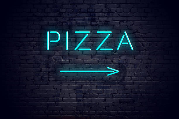 istock Brick wall with neon arrow and sign pizza 1140564580