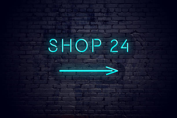 istock Brick wall with neon arrow and sign shop 24. 1140565399