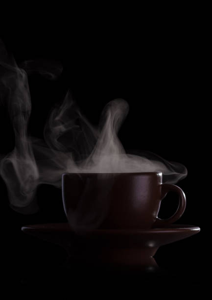 istock Cup of fragrant hot drink with steam isolated on black 1140565620