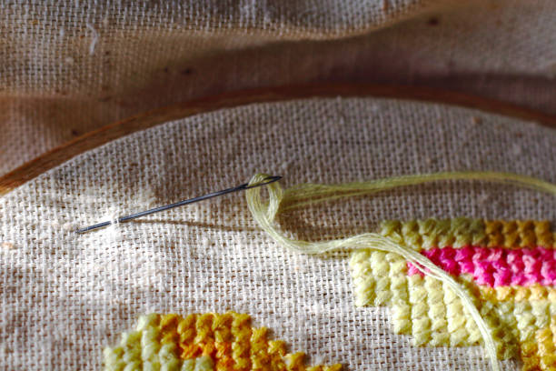 istock Cross stitch on canvas with a needle and thread. Embroidery process and sewing 1140566080