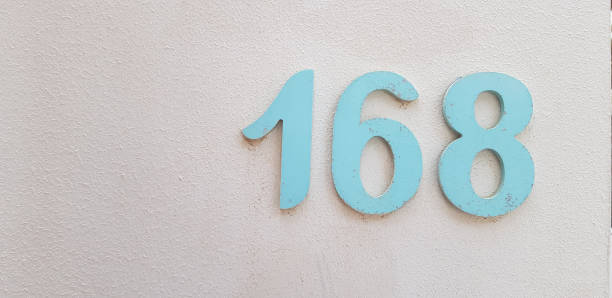 number 168 big blue digits on white painted wall