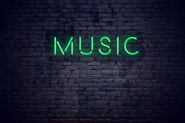 Brick wall at night with neon sign music stock photo