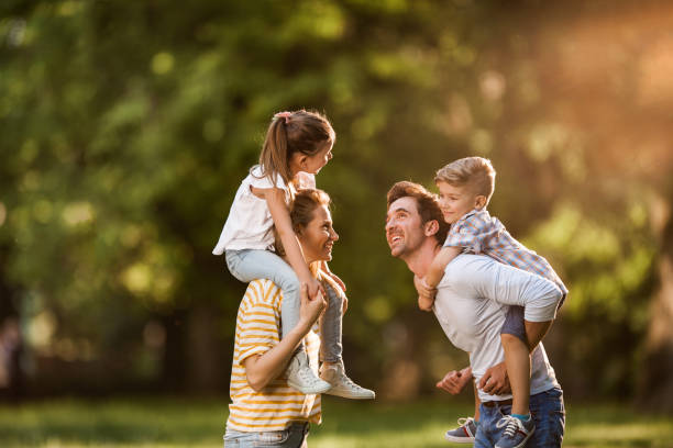 istock Carefree parents having fun with their kids in spring day. 1140569241