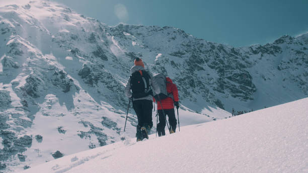 istock Winter mountain adventure. Young couple on a trail 1140569446