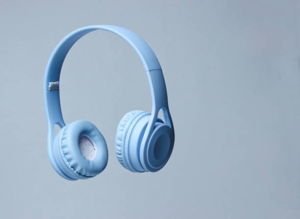 3D surround photo blue wireless headphones on gray background. stock photo