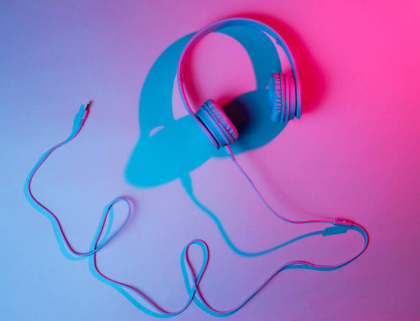 istock Headphones with cable. Retro wave, blue red neon light, ultraviolet. Top view, minimalism 1140569560