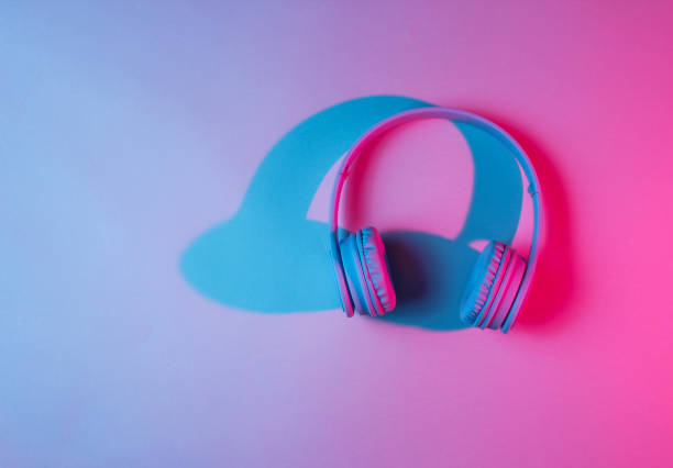 istock Wireless headphones. Retro wave, neon light, ultraviolet. Top view, minimalism 1140569576