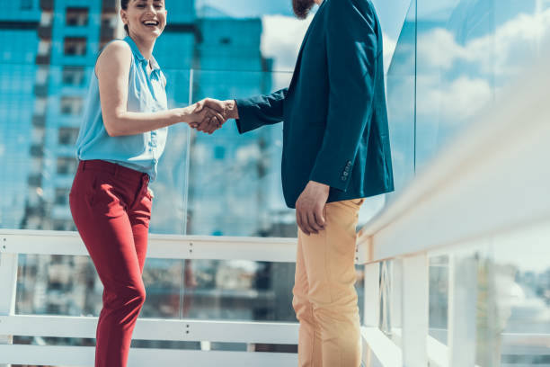 istock Glad woman greeting man during conversation outdoor 1140572061