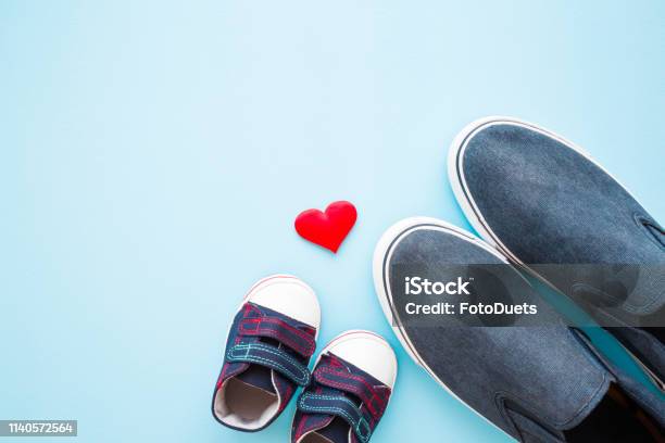 Father And Son Shoes With Red Heart Shape On Pastel Blue Background Love Concept Empty Place For Sentimental Lovely Cute Text Quote Or Sayings Flat Lay Stock Photo - Download Image Now