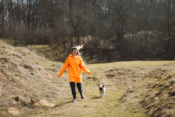 istock Woman running with dog at the forest 1140573536
