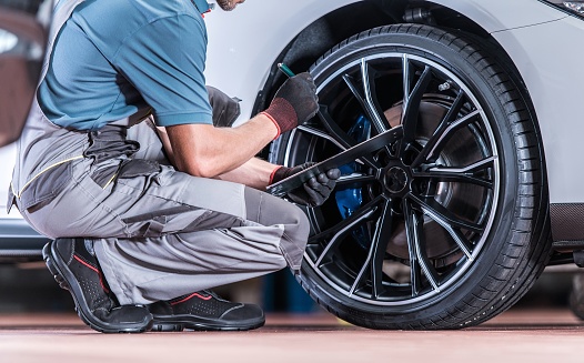 Tires and Wheels Inspection by Professional Automotive Technician in the Certified Auto Service.