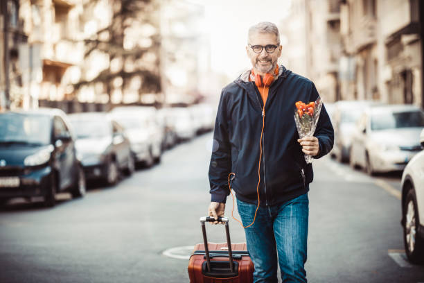 istock businessman with suitcase walking  in a city. 1140574043