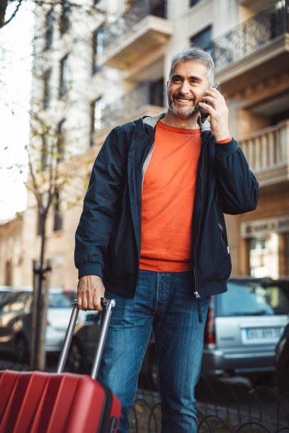 istock businessman with suitcase walking  in a city. 1140574822