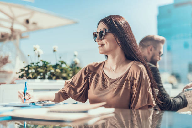 istock Happy woman writing in copybook during job 1140575358