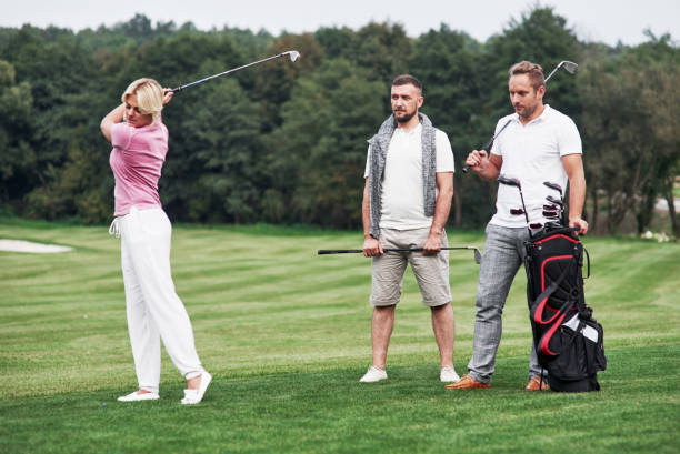 istock Three friends spending good time at the field playing golf and watching the shot 1140576390