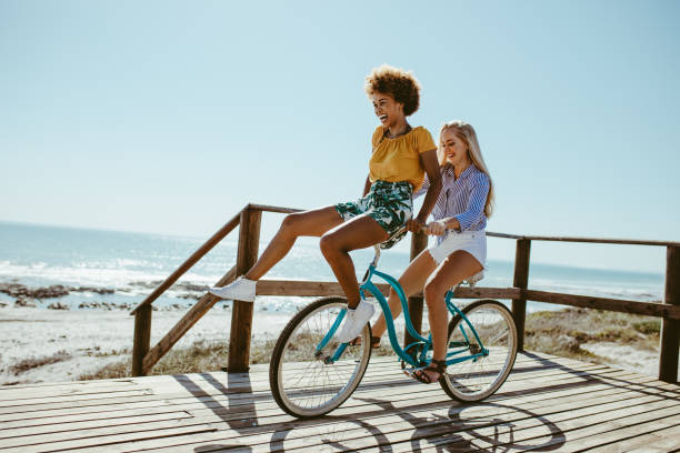 istock Girls having a great fun on bike 1140576516