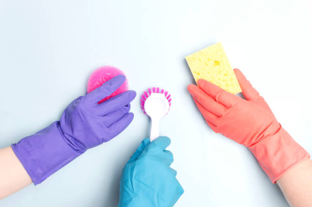 istock Cleaning team wearing protective gloves and holding different cleaning items to make clean your house.Concept of cleaning service 1140579565