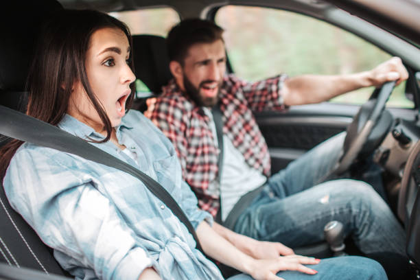 istock Young people are driving very fast. They are making an unexpected stop. Guy is screaming while girl is keeping her mouth opened and looking straight on the road. 1140579726