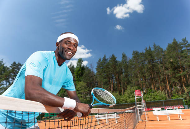 istock Cheerful guy is having good time during tennis game 1140580725
