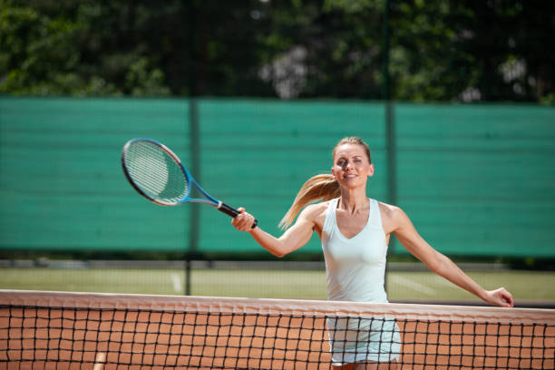 istock Optimistic woman is playing sport on court 1140580736