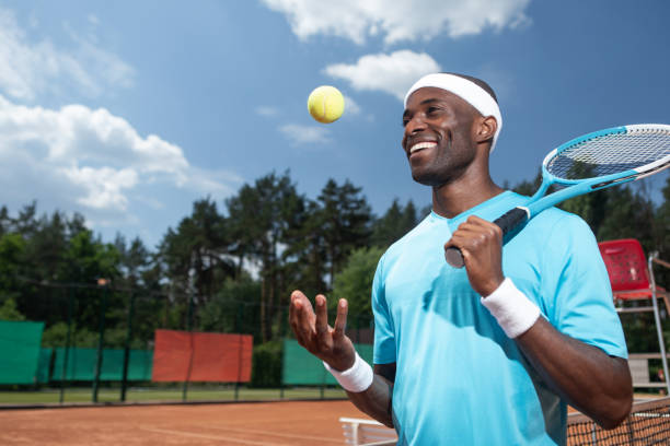 istock Cheerful man is using tennis equipment outside 1140580896
