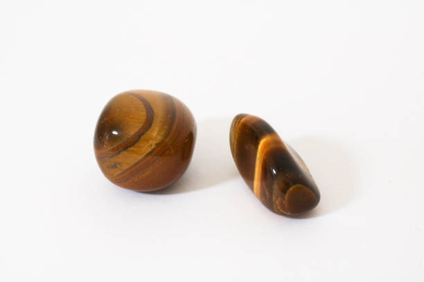 Tiger's eye, close-up of a precious stone with white background, collectibles