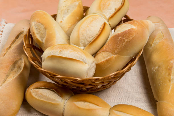 basket of french breads basket of french breads on a table grain and cereal products stock pictures, royalty-free photos & images