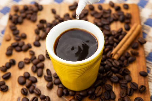 small cup of coffee being sweetened with grain background