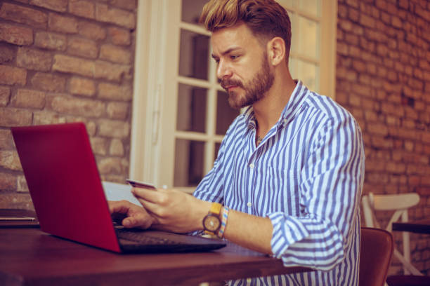 istock Bearded young male model online shopping 1140587883