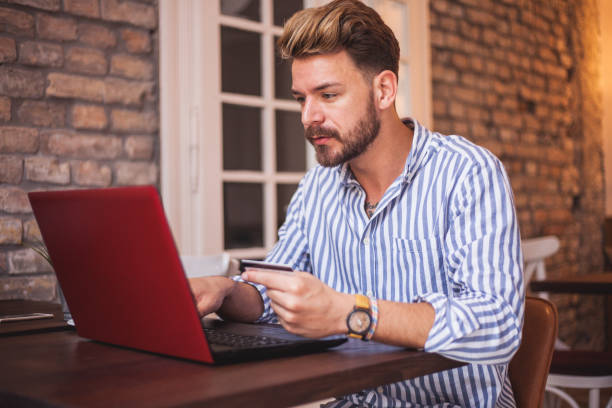 istock Bearded young male model online shopping 1140587922