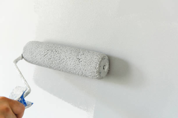 istock Hand painting wall with roll in grey color 1140587977