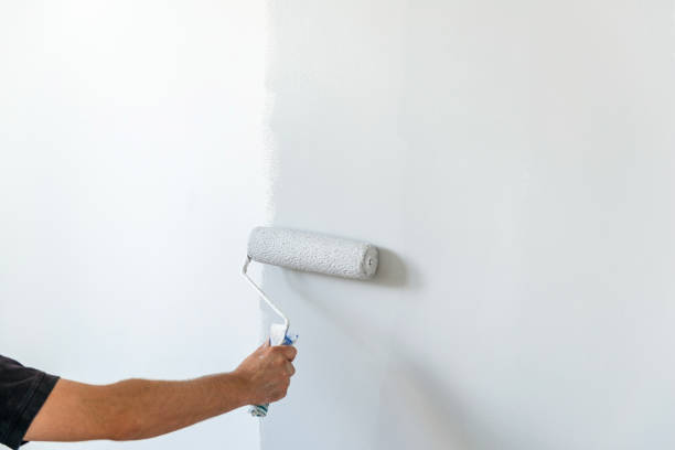 istock Hand painting wall with roll in grey color 1140587994
