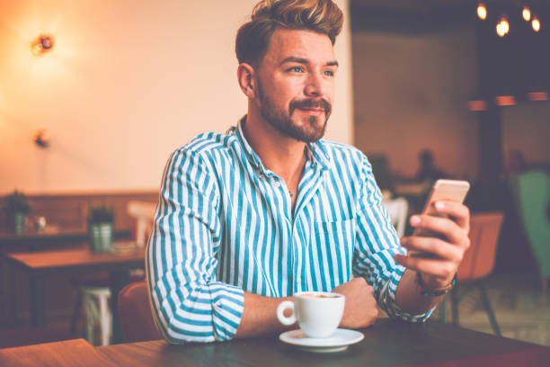 istock Young bearded stylish man using phone 1140588160