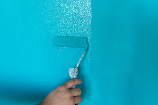 istock Hand painting wall with roll in turquoise color 1140588222