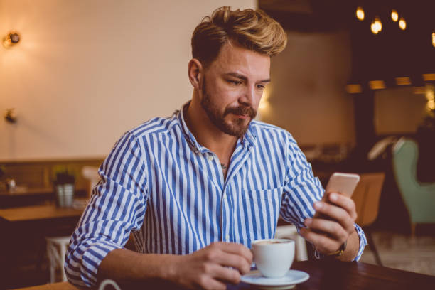 istock Young bearded stylish man using phone 1140588234